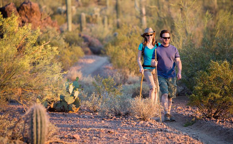 LOAN TERMINOLOGY - Couple hiking holding and holding walking sticks